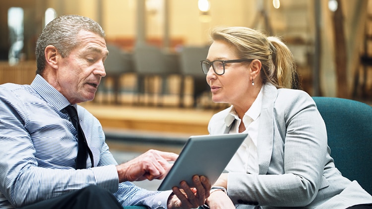 Two people discussing a file